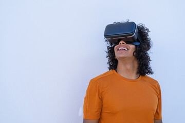 young hispanic man with virtual reality glasses on a white background