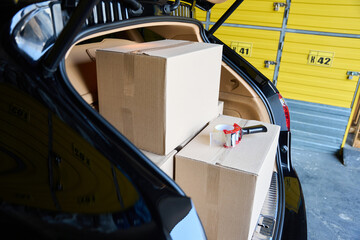 Car with an open trunk in a warehouse