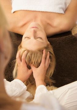Woman receiving a scalp massage
