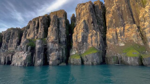 Bird colony in the Arctic sea along the northern fjords of the Svalbard Islands during a boat expedition