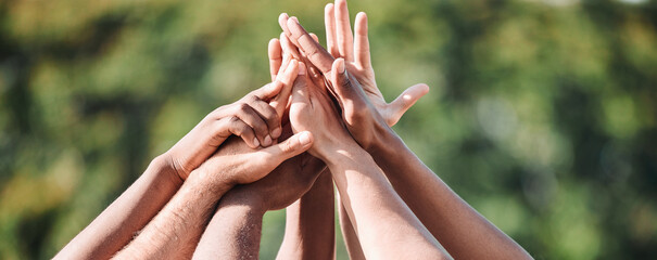 People, teamwork and high five in nature, support or collaboration for motivation or outdoor goals. Closeup of group hands together in team building, solidarity or trust in unity or community outside