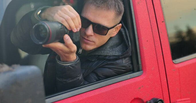 Tourist blogger photographer takes pictures of nature in open window of car. Blogger use hobby content concept enjoy trip