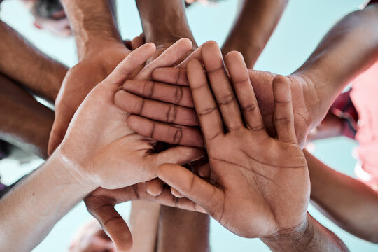 People, teamwork and hands together in motivation, collaboration or community for goals below. Closeup of group piling in team building, solidarity or trust in support for sports, rugby or match - Powered by Adobe