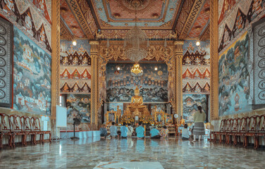 Many people are sitting pay respect to The golden buddha statue or Golden buddha image in Enshrined...