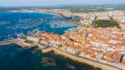 Aerial view of the old town of Alghero in Sardinia. Photo taken with a drone on a sunny day. Panoramic view of the old town and harbor of Alghero, Sardinia, Italy.