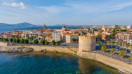 Fotobehang Aerial view of the old town of Alghero in Sardinia. Photo taken with a drone on a sunny day. Panoramic view of the old town and harbor of Alghero, Sardinia, Italy. © Grzegorz