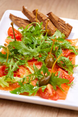 salmon carpaccio with capers and bread