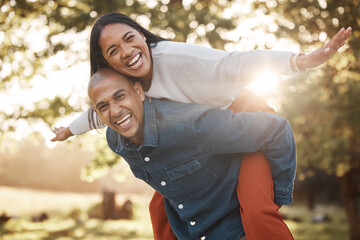 Couple, park and happy with piggy back, portrait and airplane game in nature, holiday and bonding...