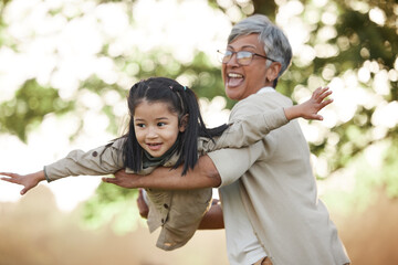 Family, girl child or grandmother with fly or airplane for fantasy play, fun game or together with bokeh in nature. People, kid or grandma outdoor with happiness for love, care and bonding or excited