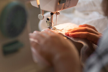 Woman use sewing machine needle Close up tailor Tailoring Process working Caucasian girl Dressmaker Female hands stitching clothing fashion designer at home beautiful.