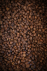 Coffee beans. Coffee beans are spread out on the surface.