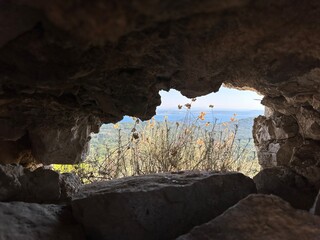 Ruins of an old fortress, a hole in the stone. Hole in the ancient fortress wall. Brick structure...