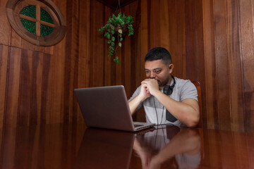 Man using laptop with headphone and smartphone. Laptop concept. Headphone concept.