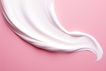 White cosmetic cream stroke on pink background. Face creme, body lotion, moisturizer. Beauty make-up product smudge, smear.