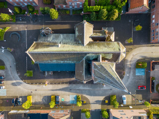 Obraz na płótnie Canvas Rijkevorsel, Belgium, 9th of June, 2022, Top down view of the church in the Little village of Sint Jozef, on the canal Dessel Schoten aerial photo during morning sunrise in Rijkevorsel, kempen