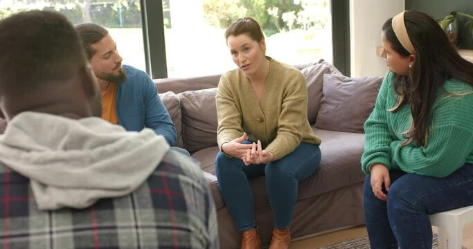 Diverse group of friends talking and supporting each other in group therapy session