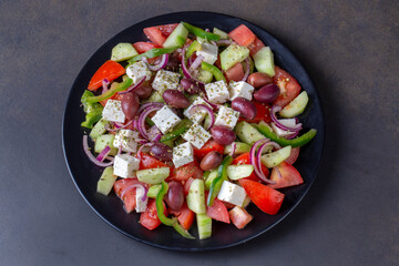 Greek salad with fresh vegetables, feta cheese and kalamata olives. Healthy food.