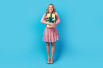 Full size photo of gorgeous cheerful girl with wavy hair dressed stylish pink clothes embrace gift box isolated on blue color background