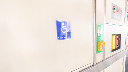 Wheelchair sign. The blue symbol of disability and accessibility at the transportation station.