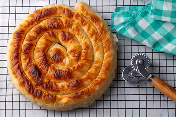 Traditional Turkish pastry with spinach. (Turkish Name: Ispanakli Kol Boregi, Bosnak boregi). Handmade pastry with spinach filling.