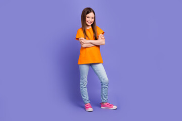 Full size photo of positive schoolgirl wear stylish t-shirt denim trousers standing hold arms...