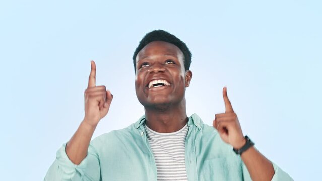 Black man, pointing up and advertising presentation with information or news with ambassador on blue background. Portrait, mockup and launch announcement with marketing and coming soon in studio
