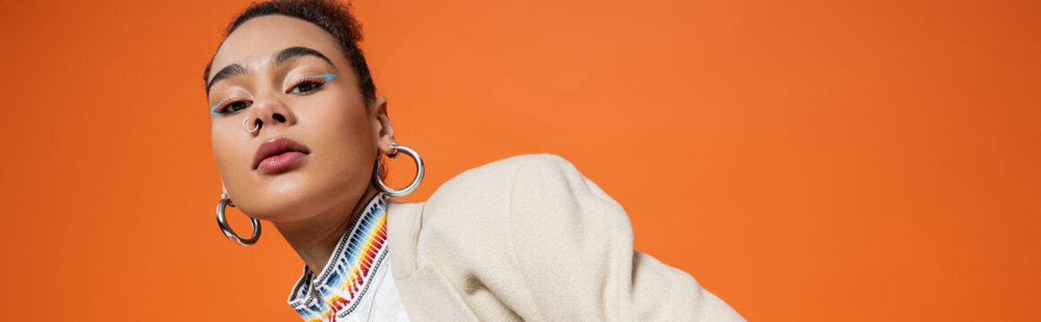 stylish african american model in urban outfit with accessories and vibrant colourful makeup, banner