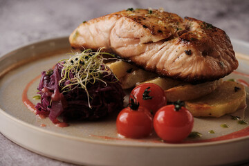 Tender Tuna Delight: A perfectly seared tuna steak rests on a bed of seasoned potatoes, a...