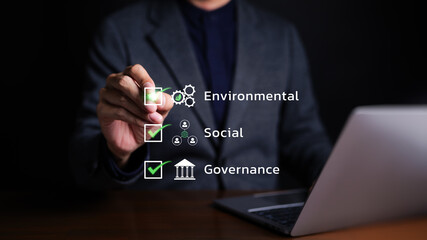 ESG environmental social governance strategy investment business concept. Businessman checking mark...