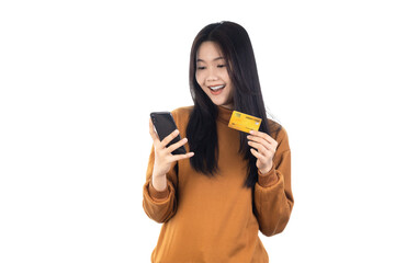 Asian woman holding credit card and looking at smartphone app, buying, order delivery in mobile phone application, standing isolated on white background with clipping path. Online shopping concept.