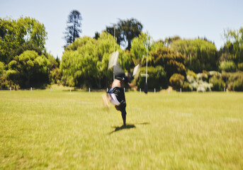 Cheerleader, blur and cartwheel on field for performance, dance and training outdoor. Cheerleading,...