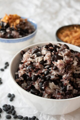 A bowl of black beans and sticky rice.