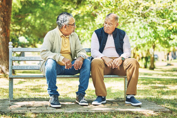 Elderly friends, relax and men on park bench, talking and bonding outdoor. Senior people sitting together in garden, communication and serious conversation in nature for retirement in the morning