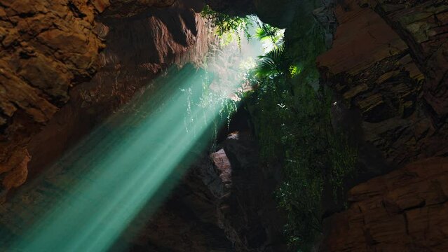 A green light shines through a cave