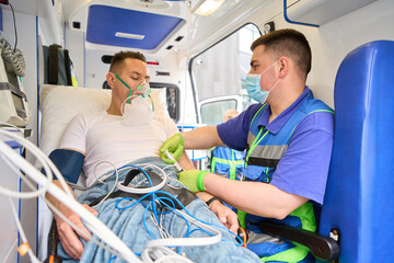 Doctor injecting medicine to patient in ambulance