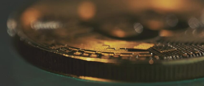 Close-up shot of camera moving around a physical concept of the digital currency Bitcoin