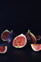 Ripe juicy figs in low key