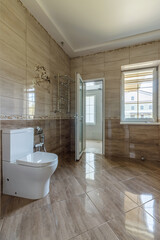Interior of an unfinished bathroom with freshly laid ceramic tiles