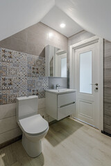 Interior of an unfinished bathroom with freshly laid ceramic tiles