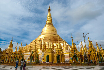 Burmese people walk around the Shwedagon Pagoda a golden Pagoda in Yangon, Rangoon, Myanmar, Asia,...