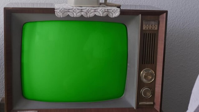 male Hand turns on TV power button, adjusts the volume control old retro analog TV, old retro analog TV with blank screen for designer, 1960-1970, stylish mockup, template for video, Retro Technology