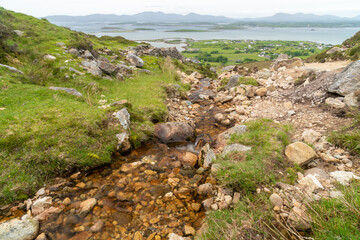 Panoramic, scenic sea and mountain landscape with islands. Stones in foreground. View from Croagh Patrick -  important site of pilgrimage in County Mayo, Ireland