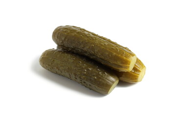  Three pickled cucumbers lie on a white background.