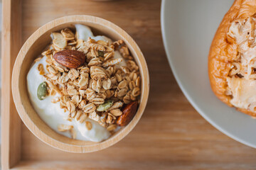 Close up of homemade breakfast. cereal granola in wooden bowl.