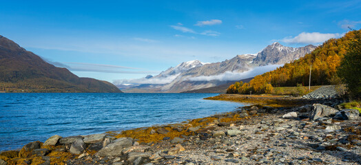 autumnal panorama in the mountains on the island of Kvaløya, in Troms, Norway. glacial valley with...