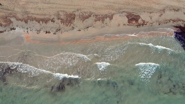 Empty sandy beach of Playa Flamenca. Aerial drone point of view water of Mediterranean Sea and coastline, no people, daytime. Costa Blanca, Province of Alicante. Spain. Travel concept

