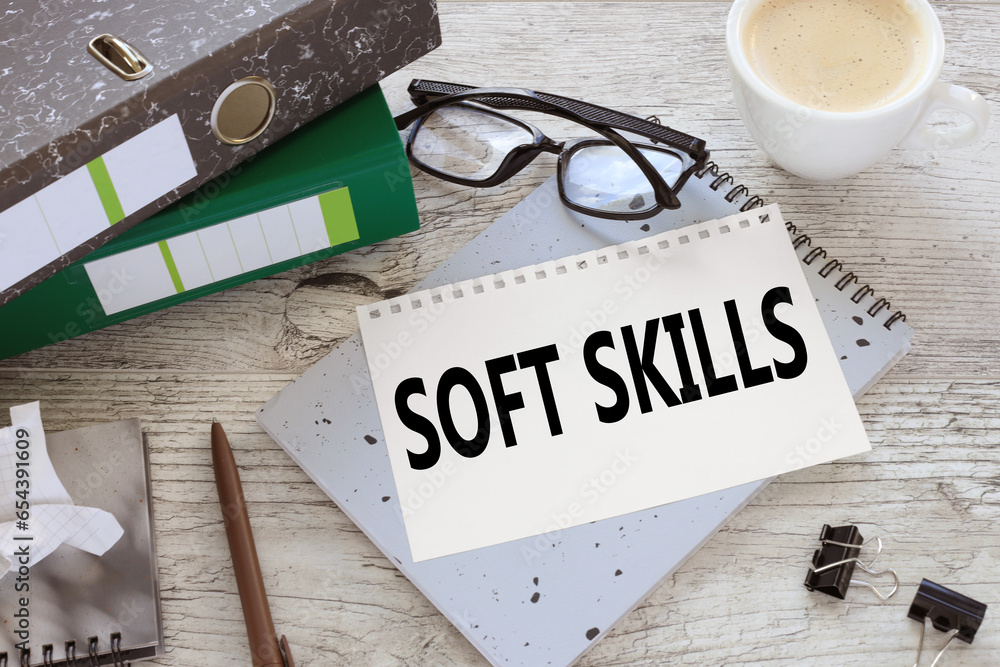 Poster soft skills torn page from a notebook on a gray notepad. folders on the table