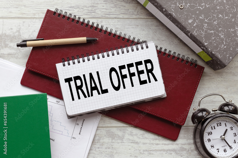 Poster trial offer. text on a notepad on a diary. work desk
