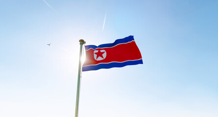 Flag of North Korea waving in the wind, sky and sun background. North Korea Flag. Ultra Hd.