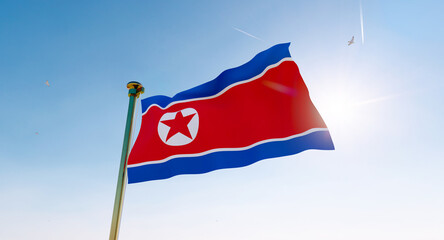 Flag of North Korea waving in the wind, sky and sun background. North Korea Flag. Ultra Hd.